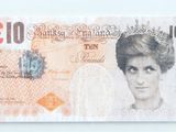 a picture of a british ten pound note on a white surface