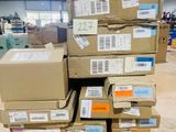 many boxes stacked on top of each other in a warehouse