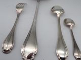 five spoons and two spoons sitting on a table