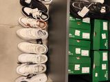 many pairs of shoes on a shelf in a shoe store