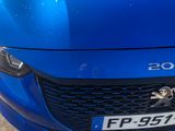 a close up of a blue car with a number plate on it