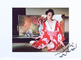 a picture of a woman in a kimono sitting on the floor