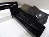 a black box with a hair dryer and other items in it
