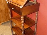 a small wooden table with a book shelf on top of it