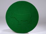 a green plate with a picture of a cow on it