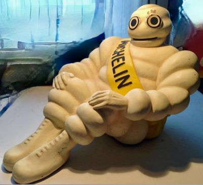 a statue of a man with a sash sitting on a table