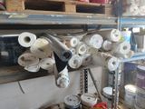 many rolls of toilet paper on a shelf in a room