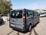 a grey van that is parked in a parking lot
