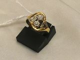 an image of a gold and diamond ring on a black stand