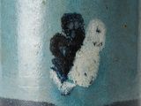 a close up of a vase with a black and white heart on it