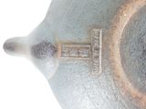 a close up of a tea pot with a handle