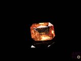 a close up of a yellow diamond on a black surface