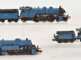 four different views of a blue toy train on a white surface