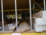 a lot of wooden planks on the shelves in the warehouse