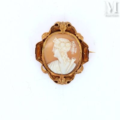 a picture of a woman in a gold broochle