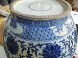 a large blue and white vase sitting on a table