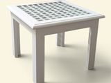 une image représentant une table blanche recouverte d'un nappage à carreaux