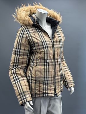 the mannequin is wearing a jacket and pants with a fur lined hood