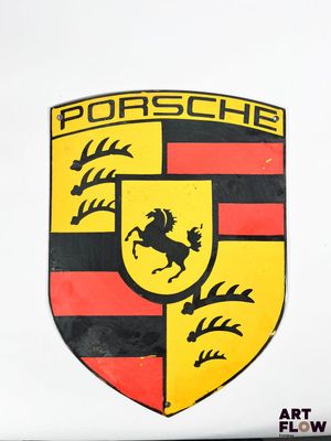 a close up of a porsche emblem on the side of a white car