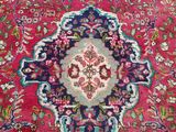 an oriental rug with a medallion design on a red background