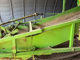 a green machine that is sitting inside of a building