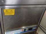 a metal cabinet with a sign on it in a kitchen