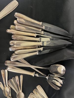 a lot of silver spoons and spoon spoons on a table