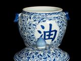 a blue and white vase with chinese writing on it