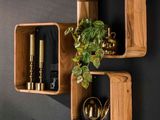 deux étagères en bois sur lesquelles sont disposées des plantes et des bougies, devant un mur noir