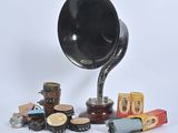 a black gramphone sitting on top of a table next to other items