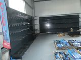 many empty shelves in a store with many different items