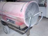a large fan sitting on top of a cart in a garage