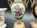three vases that have been painted with flowers on them