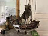 a model of a boat sitting on a table next to a mirror
