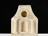 sculpture of a stone building with a hole in the middle