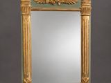 an ornately carved mirror with a green frame and gold trim