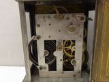 a silver clock that is sitting on a table