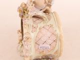 a figurine of a cupid sitting on top of a clock