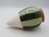 a small glass object with a black and white stripe on it