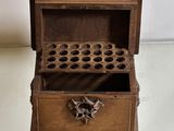 a small wooden box with a bunch of holes in it