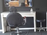 a large room with chairs and mirrors in it