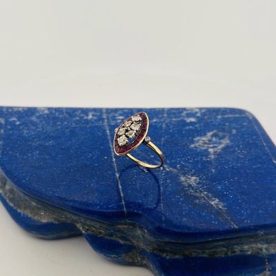 an image of a red and white ring on a blue stone