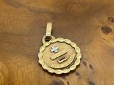 an image of a gold pendant with a cross on it