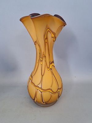 a yellow vase that is sitting on a table