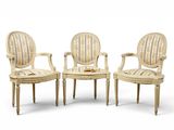 trois chaises blanches avec des accoudoirs rembourrés à rayures et des pieds