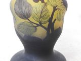 a vase with a bird on it sitting on a table