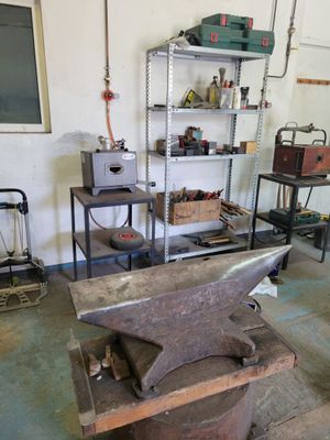 a blacksmith ' s workshop with an anvil on the table