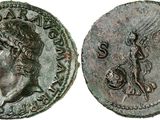 a silver coin with a head of a man and a bird on it