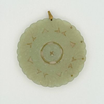 a picture of a green pendant with a star on it
