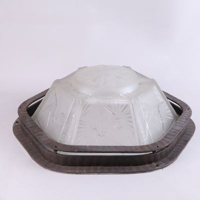 a glass bowl with a wooden base on a white surface